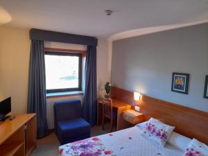 Cama ou camas em um quarto em Hotel das Taipas