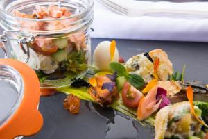 a mason jar filled with food on a table at The Glenmoriston Townhouse Hotel in Inverness