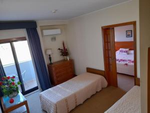 Cama ou camas em um quarto em Hotel das Taipas