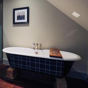 a bath tub in a bathroom with at Hotel Du Vin Edinburgh in Edinburgh