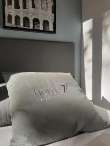 un cuscino con il nome di un hotel su un letto di B&B Home 77 a Roma