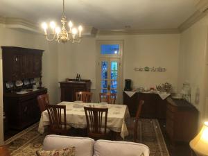 a dining room with a table and chairs and a chandelier at Cider House Bed and Breakfast in Waynesboro