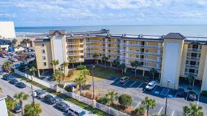 an aerial view of a hotel with a parking lot at 214 COV - Go Fly a Kite - Oceanfront Condo - 2 Pools in Folly Beach