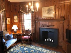 a living room with a fireplace and a couch at Cider House Bed and Breakfast in Waynesboro