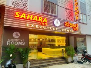 a store front of a restaurant with neon signs at SAHARA Inn in Bangalore