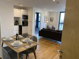 a kitchen and living room with a table and chairs at Arden Gate Apartments in Birmingham