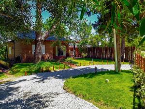 a house with a yard with a fire hydrant in the driveway at Cabañas Bruma in Monte Hermoso