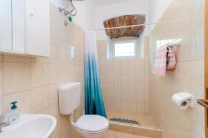 a bathroom with a shower and a toilet and a sink at Apartments Massimo in Rovinj +48 photos