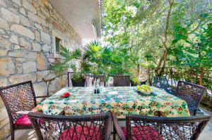 a table with chairs and a table cloth on a patio at Apartments Massimo in Rovinj