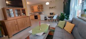 a living room with a couch and a table at Ferienwohnung Weinbergblick in Naumburg