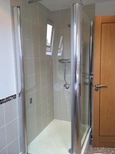 a shower with a glass door in a bathroom at Southover Beach in Woolacombe