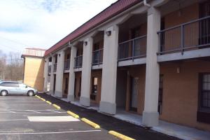 a car parked in a parking lot next to a building at Executive Inn in Tullahoma