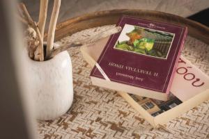 a book sitting on a table next to a vase at Casa Maria in Lithakia