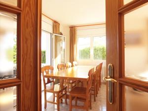 a dining room with a table and chairs at Villa Nerea with air conditioning & private swimming pool only 400m to the beach ideal for families in L'Ametlla de Mar