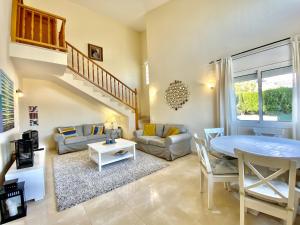a living room with a table and a couch at Villa Martina 4 bedroom villa with air conditioning & private swimming pool ideal for families in L'Ametlla de Mar