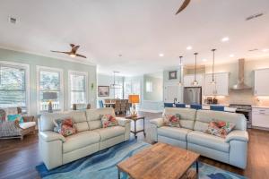 a living room with two couches and a kitchen at 316 E Hudson - The High Tides - Hot Tub - 4 Bedrooms in Folly Beach