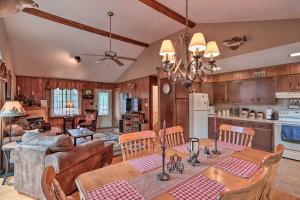 a kitchen and living room with a table and chairs at Poconos Home with Game Room Walk to Lake Harmony! in Lake Harmony