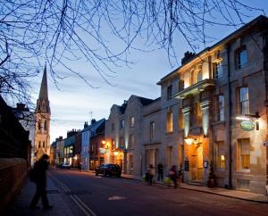 a city street with buildings and a church at Vanbrugh House Hotel in Oxford
