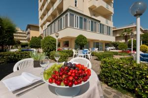 a bowl of fruit on a table in front of a building at Diplomatic in Cervia