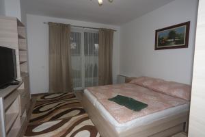 A bed or beds in a room at Ádám Guesthouse I.