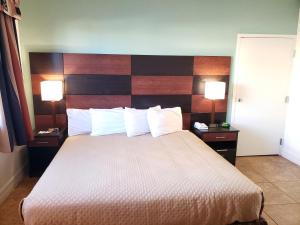 A bed or beds in a room at Oceanfront Inn and Suites - Ormond