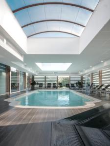 a large swimming pool in a large room at Relais De La Malmaison Paris Rueil Hôtel-Spa in Rueil-Malmaison