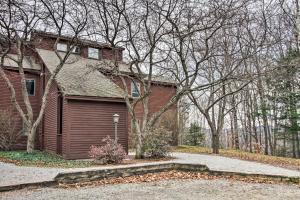 a house with a garage in front of it at Ski-in Ski-Out Okemo Oasis with Deck and Mtn View! in Ludlow