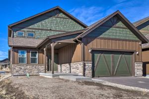 a house with a gambrel roof and a garage at Home with Private Hot Tub Near Skiing and Rocky Mtn NP in Granby