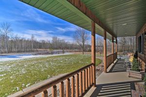 a covered porch with a view of a field at Homey Gresham Getaway Ski, Hike, Explore and Relax! 