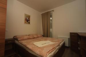 A bed or beds in a room at Ádám Guesthouse I.