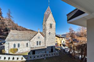 una imagen de una iglesia con campanario en Chesa Cuntainta - St. Moritz, en St. Moritz