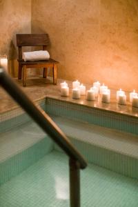 a swimming pool with white candles in a room at CasaSur Recoleta in Buenos Aires