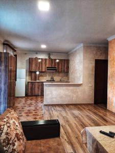 a large kitchen with wooden floors and a counter top at Cottage Tsaghkadzor in Tsaghkadzor