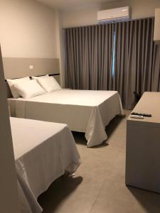 Ένα ή περισσότερα κρεβάτια σε δωμάτιο στο Raf Hotel
