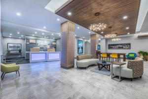 a lobby of a hospital with chairs and tables at Holiday Inn Express & Suites Moncton by IHG in Moncton