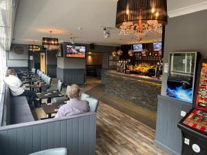two people sitting at a bar in a restaurant at The Windsor Hotel and Bar in Kirkcaldy