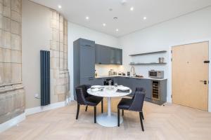 a kitchen with a table and chairs in a room at Luxury Romantic Church Getaway in Finchley
