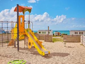 a playground with a slide on the beach at La côte sauvage - MH climatisé 2018 - P30 - Le Portel in Le Portel
