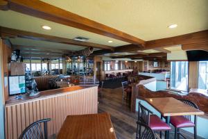 a restaurant with tables and chairs and a bar at Clover Island Inn in Kennewick