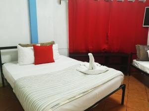 a room with two beds with red and white pillows at Hotel Cafe Del Mar, En Valle Pura Vida in Manuel Antonio