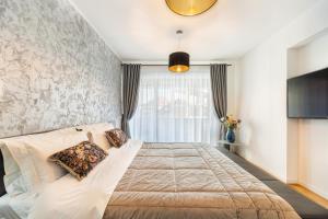 a bedroom with a large bed and a window at The Wolf Residence in Braşov