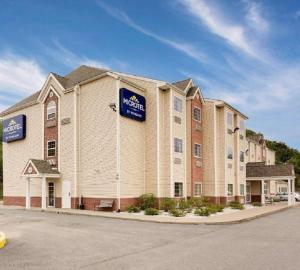 a large building with a sign on the side of it at Microtel Inn & Suites by Wyndham Princeton in Princeton