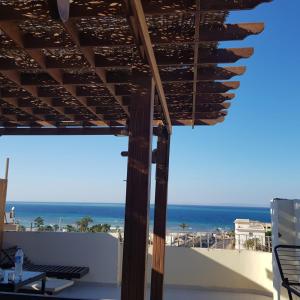 a view of the beach from the balcony of a house at Sweet Home Flat 1 in Hurghada