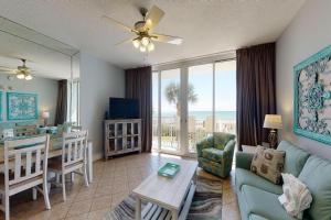 a living room with a couch and a table and a dining room at Waters Edge II in Fort Walton Beach