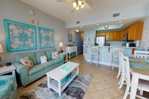 a living room and kitchen with a couch and a table at Waters Edge II in Fort Walton Beach