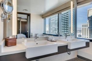 a bathroom with two sinks and a large window at Jet Luxury at The Vdara in Las Vegas