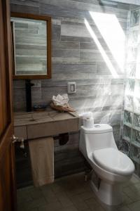 a bathroom with a toilet and a sink at Las Casitas in Rincon de Guayabitos