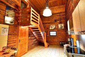 a kitchen with a spiral staircase in a wooden house at FEWO Wittener Hütte in Langenbach b.K. in Langenbach bei Kirburg