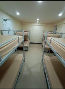 a room with several bunk beds in it at Snoozeph in Manila
