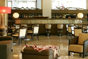 a restaurant with chairs and tables and a bar at Hotel Antonios in Olympia